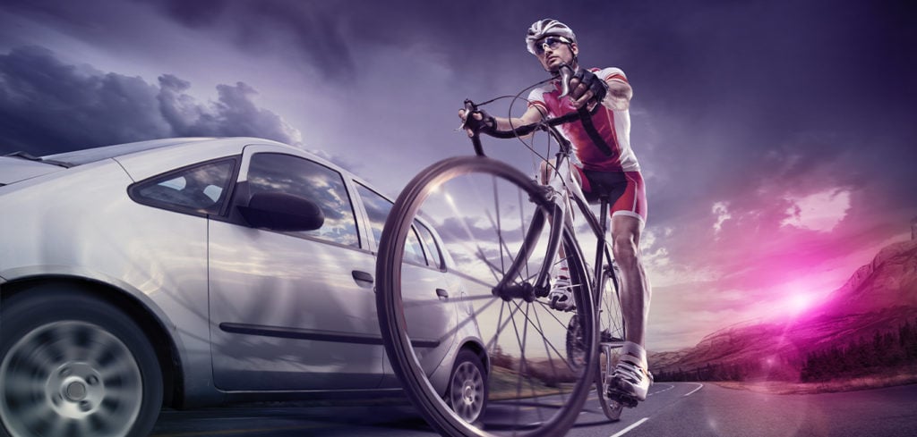 a cyclist getting ready to race with a car